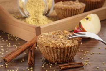 Fototapeta na wymiar Fresh muffins with millet groats, cinnamon and apple baked with wholemeal flour, delicious healthy dessert