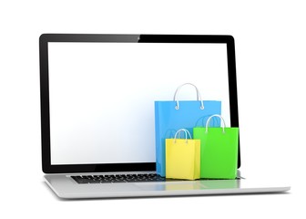 laptop and  shopping pags on white background