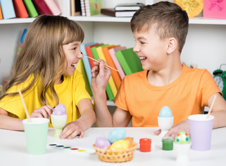 Fototapeta premium Cute children coloring eggs for easter