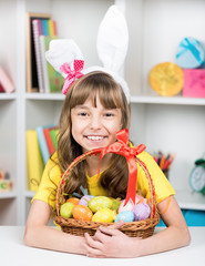 Little girl with basket of Easter eggs