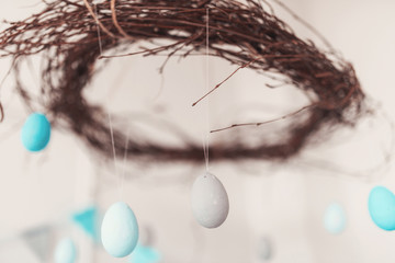 Beautiful colored eggs hanging from the top in the Easter interior