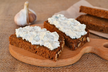 Sandwiches with soft cheese, pieces of bread, garlic