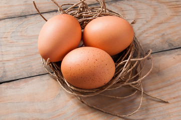 three eggs in a nest of thread