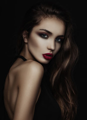 Fototapeta premium Portrait of a girl with long hair in a low key.