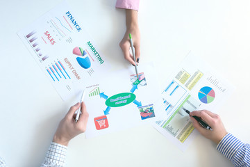 Top View of Business Meeting with Charts on White Desk