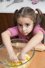 Lovely little girl kneading dough