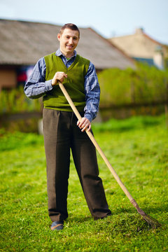 happy young adult man with disability working in spring garden