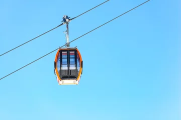Fotobehang Isolated ski resort gondola on a slear blue sky background © pirke