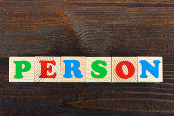 the word from children's wooden blocks with colorful letters on wooden table