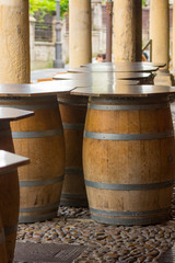 wine barrels, as supports for tables on a street