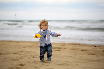 Joyful baby boy on beach