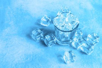 glass of ice cube on wet floor cool filter tone