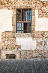 Window with bars on old wall