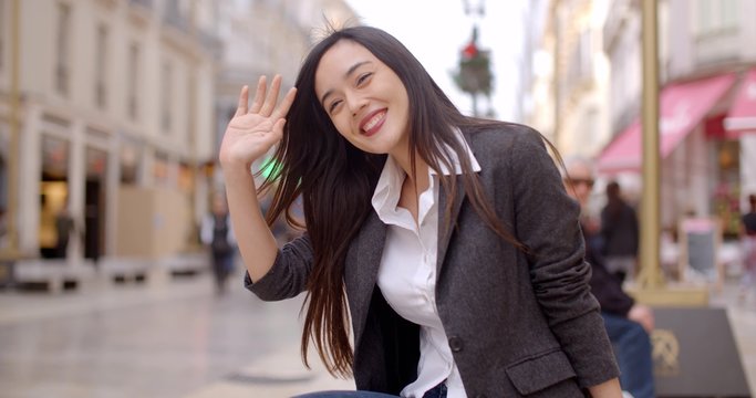 Relaxed attractive young woman sitting on a bench in town waiting for someone  close up view with copy space