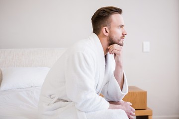 Fototapeta premium Serious man in bathrobe looking away