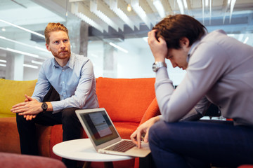 Bsuiness colleagues relaxing on sofa