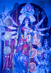 MUMBAI, INDIA - October 20, 2015: An idol of revered goddess Durga standing in the temporary temple in the city of Mumbai during Durga Puja festival celebration.