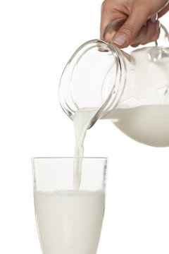 pouring milk from the carafe into a glass
