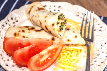 Crepes stuffed with cheese and spinach.