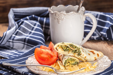 Crepes stuffed with cheese and spinach.