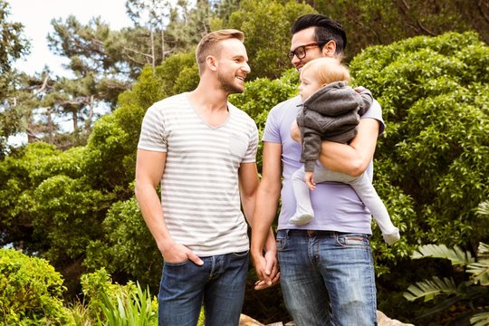 Smiling gay couple with child 