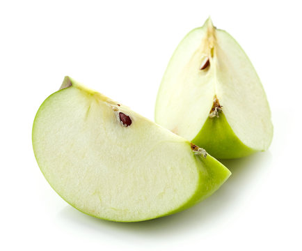 Slices of green apple on white background