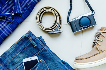 set of clothes and accessories for men on a ceramic background