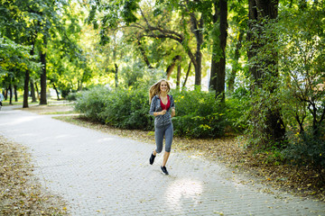 Young blonde woman jogging