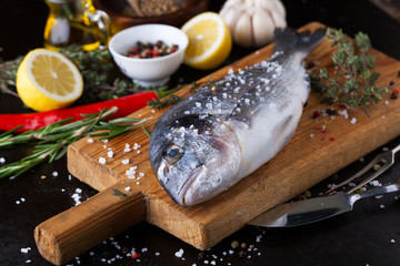 Fresh fish dorado with fragrant spices, herbs and spices