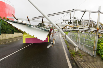 billboard demolished by wind in the highway in stormy day