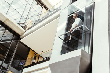 Businessman taking the elevator - Powered by Adobe