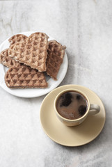 heart shaped waffles and coffee on table