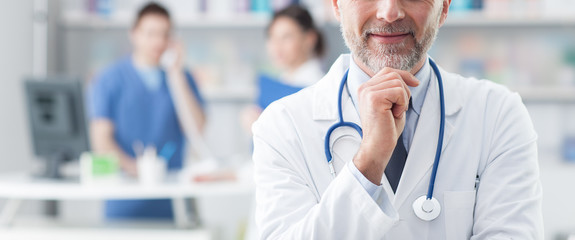 Confident doctor posing in the office