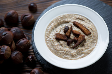 Close-up of chestnut cream-soup with croutons, studio shot