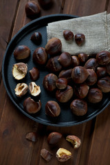 Frying pan with roasted chestnuts, high angle view