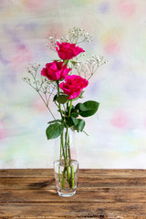 Three bright pink roses