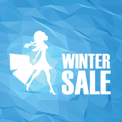 Winter sale poster template on modern blue white low poly vector background. Sexy fashion model woman with shopping bags.