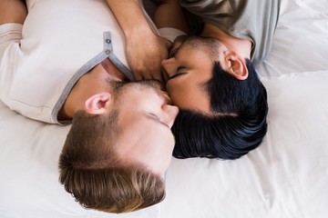 Overhead view of couple sleeping on bed