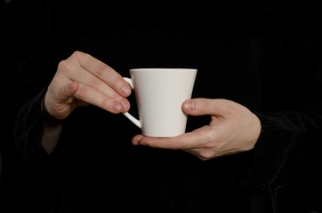 white cup of coffee in hands isolated