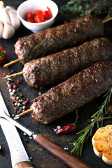 Grilled minced meat on a skewer with garlic, rosemary and spices