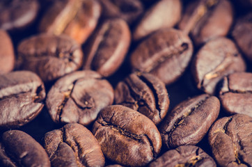 Coffee beans on a black background. Raw coffee beans. Grained product. Hot drink. Close up.