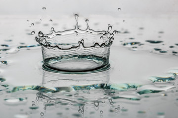Water splash  with crown on glass reflection shadow