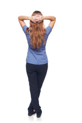 Back view of a woman standing with hands over head