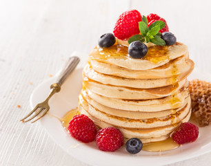 Stack of pancakes with fresh berries