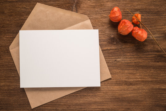 Flowers and envelope on a wooden background 