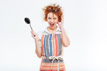 Housewife with curly hair in apron holding soup ladle