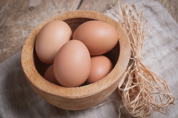Eggs in wooden bowl