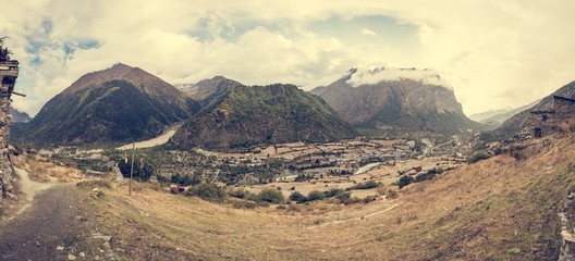 Mountain panorama with traditional stone build village. 