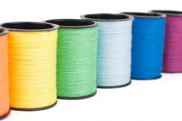 Thread bobbins in a row close-up