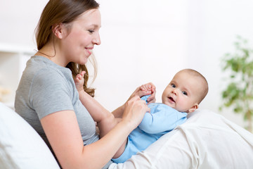 Mother looks and playing with baby.  Maternity happiness.